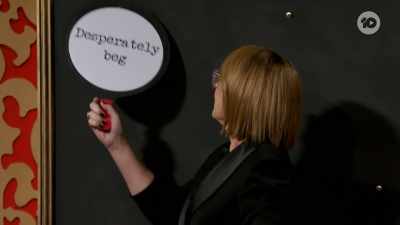 Julia has one paddle remaining
and it says, "Desperately beg." - Taskmaster