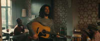 [Junior strums electric guitar] - Bob Marley: One Love