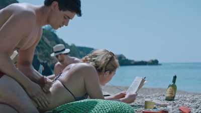 -Lie.
-It's "lie with his mother." - The Little Drummer Girl