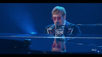 ♪ Looking on, she sings the songs ♪ - Elton John Live: Farewell from Dodger Stadium