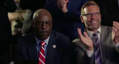 MAN [over TV]: The
people have spoken! - God's Not Dead: In God We Trust