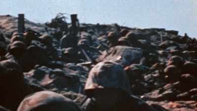 Men are pinned down in waves. - The Pacific War in Color