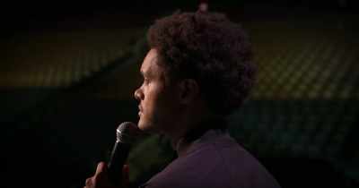-[mid-tempo rock intro plays]
-[audience cheering, muted] - Trevor Noah: I Wish You Would