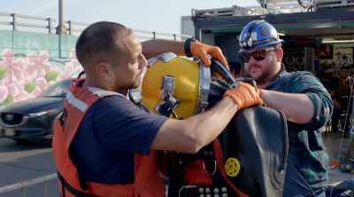 [narrator]  90 extra pounds
of weight - Sewer Divers