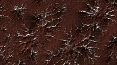NARRATOR: Carved into the surface
by exploding jets of carbon dioxide, - Mars: One Day on the Red Planet