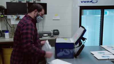 Narrator: Next, the
team packs vials - The Vaccine: Conquering COVID