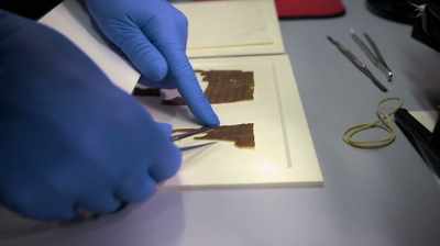 Narrator:
They photograph the scrolls - Dead Sea Scrolls: The Doomsday Prophecy