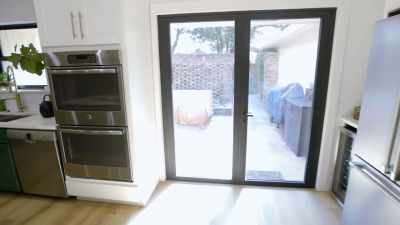 - [Natalie chuckles]
- [Russell] And now
all kitchen. - Renovation Impossible