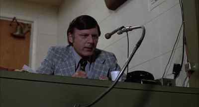Ned Braden is starting to take
off articles of his uniform. - Slap Shot