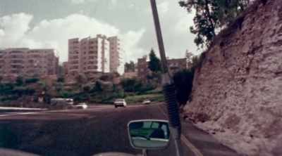 [newscaster speaking Hebrew on radio] - The Devil Next Door