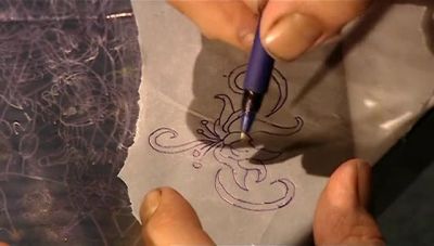 NEXT, HE PLACES THE TRACED IMAGE
ON CARBON PAPER - How It's Made
