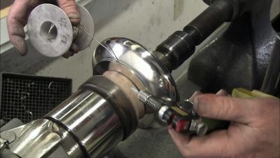 NEXT, HE TACK SOLDERS THE BASE
TO THE BOTTOM - How It's Made