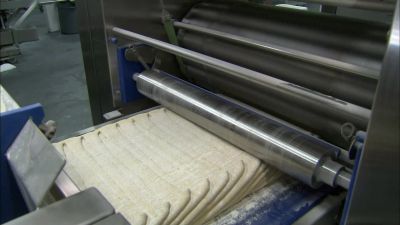 NEXT, ROLLING PINS
SQUEEZE THE STACK OF DOUGH - How It's Made