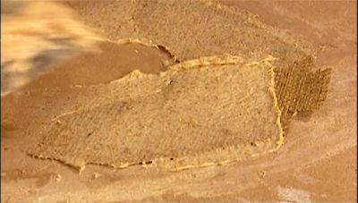 NEXT THEY SATURATE TWO PIECES
OF BURLAP WITH PASTE - How It's Made