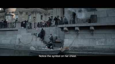 Notice the symbol on her chest. - The Ninth