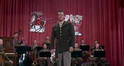 Now, we bring you a number
by the Caroling Carusos - Captain Newman, M D