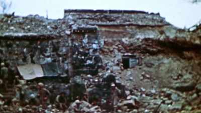 Of shells into that thing
just kicking it up in dust. - The Pacific War in Color