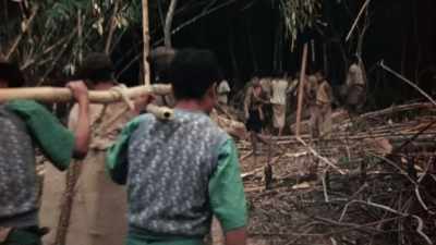 OSS OPERATIVES FUNNEL IN
A STEADY STREAM OF WEAPONS. - The Pacific War in Color