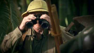 Peering through binoculars, - Tales From The Explorers Club