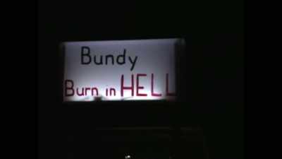 PROTESTERS:
[inaudible singing] - Ted Bundy: Falling for a Killer