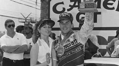 Pruett uses her as a shield. - Uppity: The Willy T. Ribbs Story