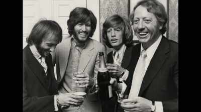 Put Maurice on."
[champagne cork pops] - The Bee Gees: How Can You Mend a Broken Heart