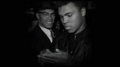 Reporters are asking Malcolm questions - Blood Brothers: Malcolm X and Muhammad Ali