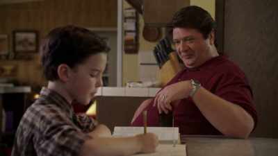 (rock music playing loudly
over stereo) - Young Sheldon