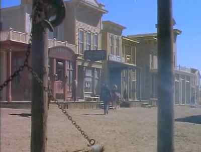 Say, do you reckon that he means to take the bank? - A Gunfight