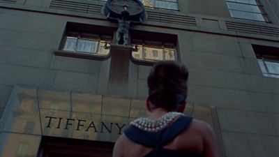 She has a croissant
in her hand, pearls - Audrey