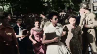 SHE IS FOLLOWED
BY AN ANGRY CROWD. - America in Color