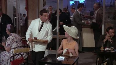 She seats herself at a table at this little caf she goes to - Paris When It Sizzles