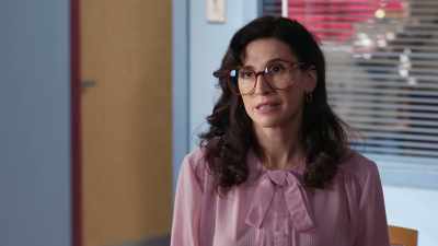 She wears glasses
that are clearly - Schooled