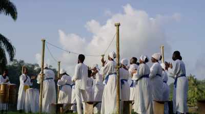 [singing and clapping] - The Burial of Kojo