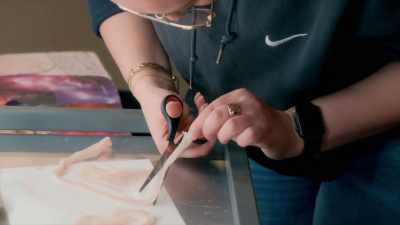 So Samah is cutting around her prosthetic. - Glow Up: Britain's Next Make-Up Star