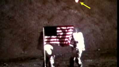 Something else reflects light 1-2 meters
over the astronaut's head, - American Moon