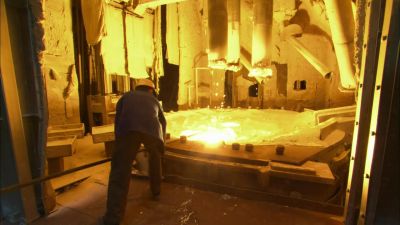 STANDING WELL BACK
AND USING A LONG LADLE, - How It's Made