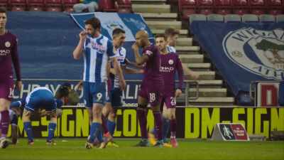 Surrounded by Wigan players the referee. - All or Nothing: Manchester City
