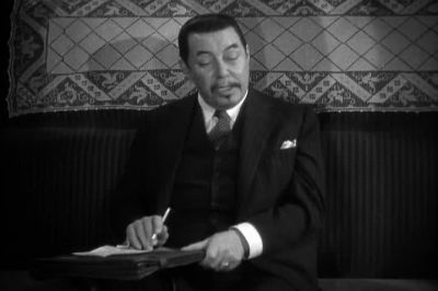 Suspect husband like toupee on bald head - Charlie Chan at the Olympics