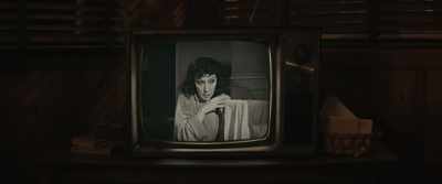 [suspenseful music playing on TV] - The Black Phone