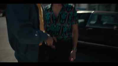 Table in back. Blue shirt. - Narcos: Mexico