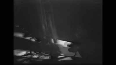 Takes a few steps back
and takes his first photographs, - American Moon