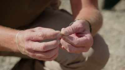 That is a coin.
It is caked in mud. - Beyond Oak Island