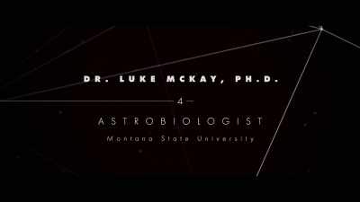 That says "Dr. Luke McKay, Astrobiologist," - The Most Unknown
