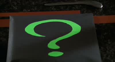 I don't know I didn't see anyoneThat's hideous What does it meanIt's a riddleNumbers on my face 13One through 12 The answer is a clockWho would send you a riddleThat Maggie is the riddle - Batman Forever