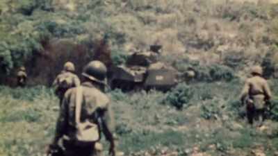 THE AMERICAN ADVANCE
IS A STEADY, GRINDING PUSH, - The Pacific War in Color