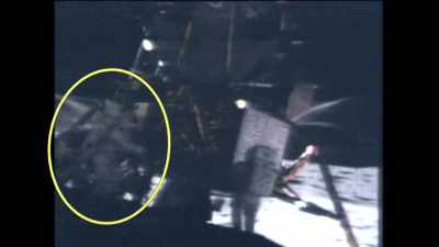 The astronaut on the left
leaps forward, - American Moon
