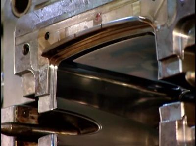 THE HOT PLASTIC
MELTS THE LABELS ON CONTACT, - How It's Made