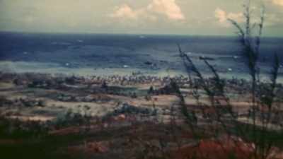 THE LANDING BEACHES REMAIN
IN SIGHT BEHIND THEM, - The Pacific War in Color