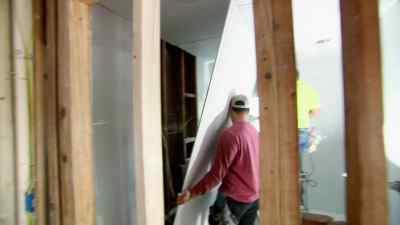 The team gets to work,
laying fresh sheetrock - Zombie House Flipping